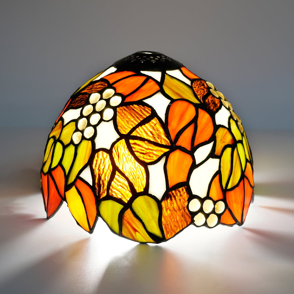Tiffany stained glass lampshade, floral motif and amber cabochons