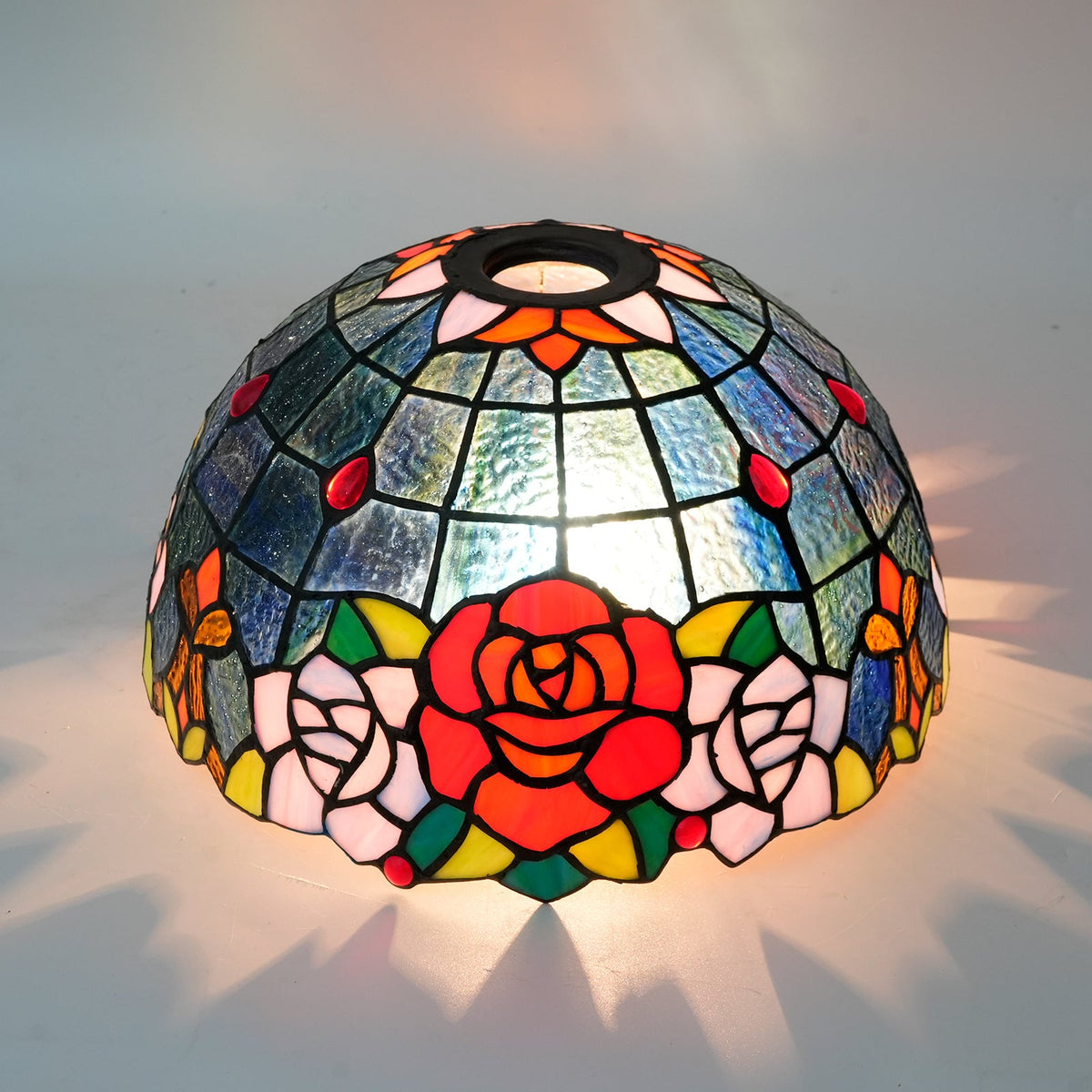 Tiffany-style tinted glass lampshade with a rose pattern