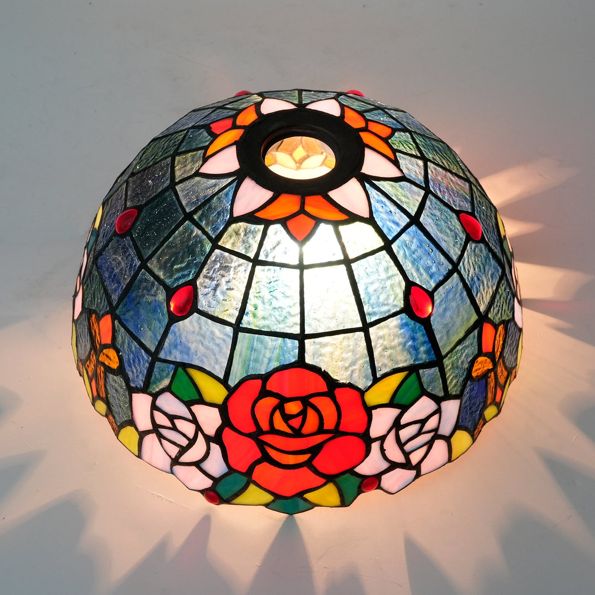 Tiffany-style tinted glass lampshade with a rose pattern