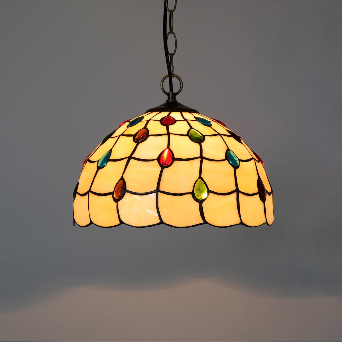 Tiffany-style stained glass pendant light in amber and multicoloured colours.