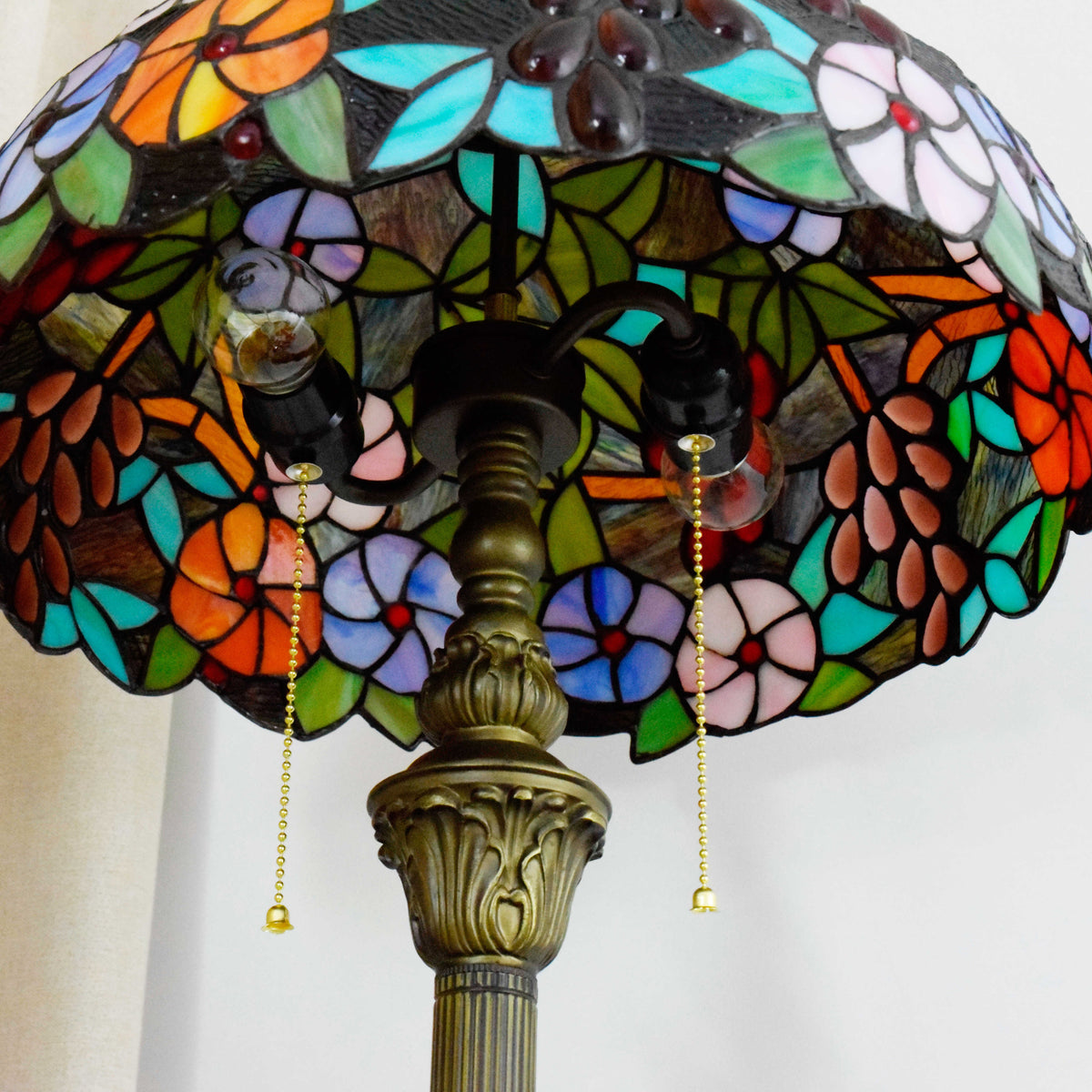 Tiffany-style lamp in stained glass with floral and grape cluster motifs