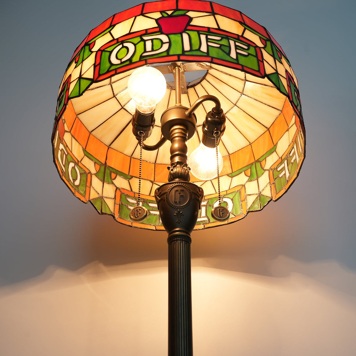Tiffany stained glass floor lamp with apple and letter motifs