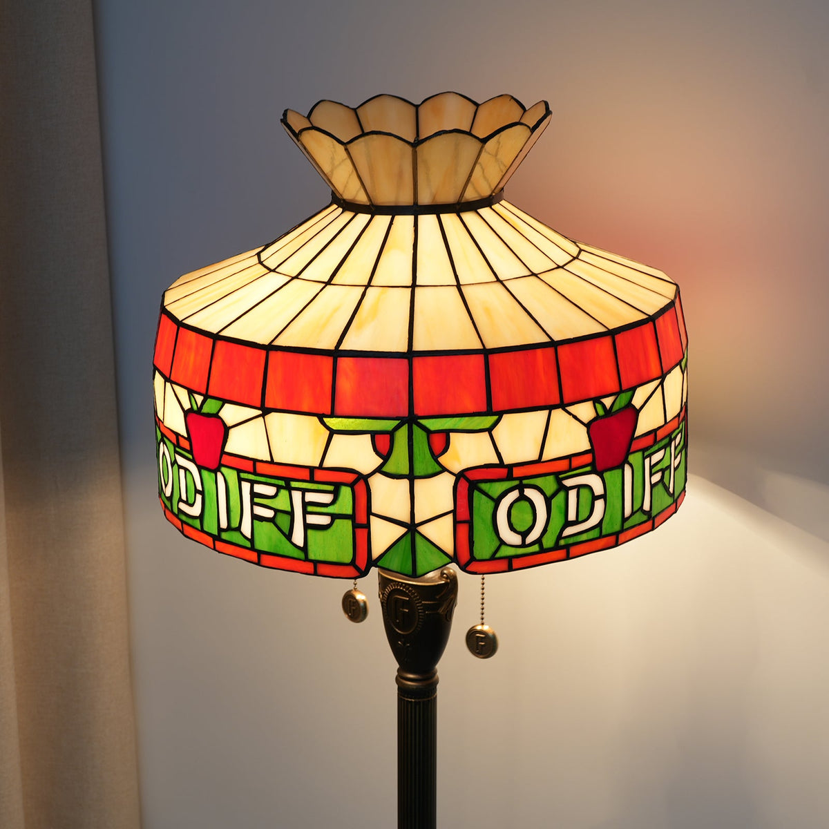 Tiffany stained glass floor lamp with apple and letter motifs