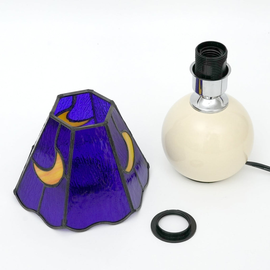 Blue stained glass bedside lamp with moons on a cream base