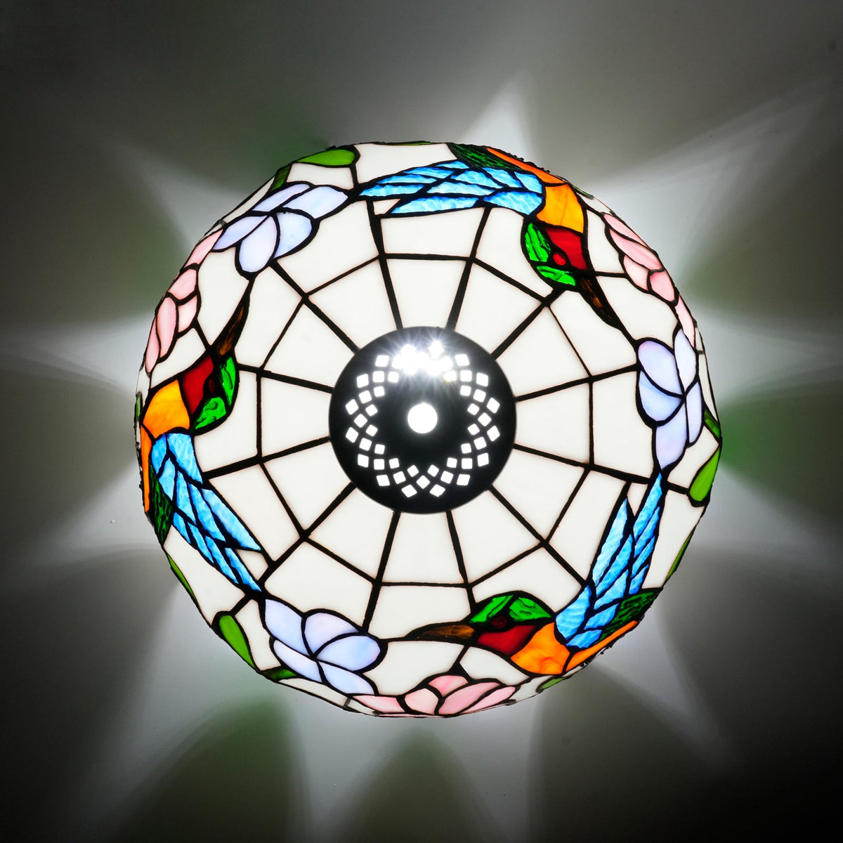 Tiffany-style lampshade in stained glass with a hummingbird and flower design.