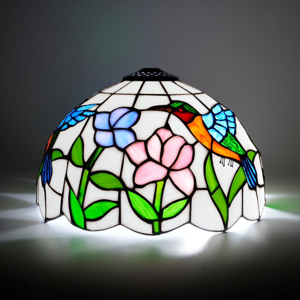Tiffany-style lampshade in stained glass with a hummingbird and flower design.
