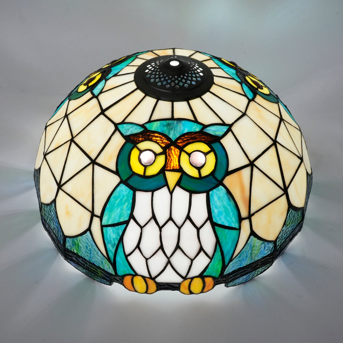Tiffany-style stained glass lampshade with a blue-green owl design