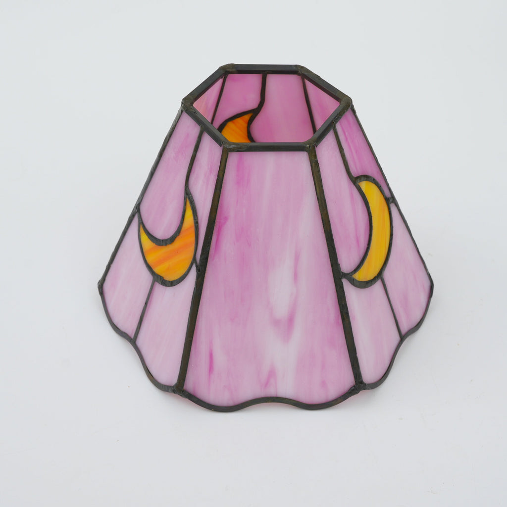 Pink tinted glass lampshade with yellow moons