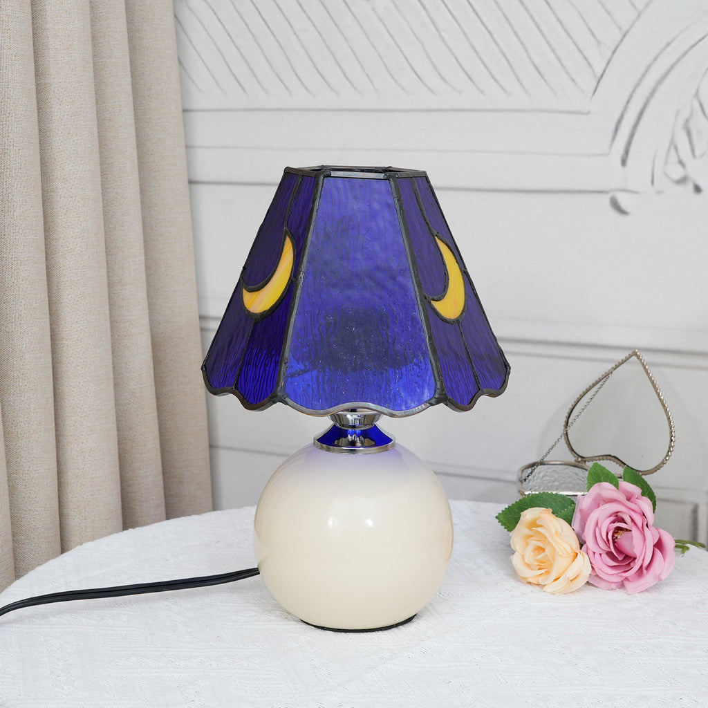 Blue stained glass bedside lamp with moons on a cream base